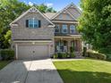 Two story home with a well maintained lawn and a welcoming front porch at 4022 Roberts Crest Dr, Suwanee, GA 30024