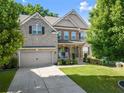 Beautiful two story home boasting a green lawn and stone details at 4022 Roberts Crest Dr, Suwanee, GA 30024