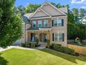 Charming two-story home with manicured lawn and an inviting front porch at 4022 Roberts Crest Dr, Suwanee, GA 30024