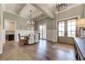 Elegant dining room with beamed ceilings, wood floors, and a chandelier over the table with seating for six at 00 Memory Ln, Canton, GA 30115