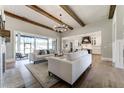 Spacious living room with exposed beams, fireplace, and large sliding doors that lead to the outdoors at 00 Memory Ln, Canton, GA 30115