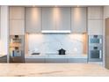 Modern kitchen featuring stone countertops, sleek cabinetry, and stainless steel appliances for a stylish and functional space at 1065 Peachtree Ne St # 3504, Atlanta, GA 30309