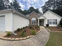 Lovely home with stone details, well-maintained lawn, and an inviting entrance at 2840 Alcovy River Vw, Dacula, GA 30019