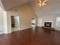 Bright living room boasting hardwood floors, a fireplace, and access to the backyard at 2840 Alcovy River Vw, Dacula, GA 30019