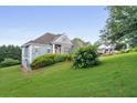 Exterior elevation of home showing nicely manicured front lawn with partial driveway at 300 Towne Overlook Cir, Canton, GA 30114