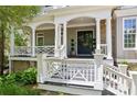 Inviting front porch with stone accents, white columns, and decorative railings, offering a welcoming entrance at 3903 Hazelhurst Dr, Marietta, GA 30066