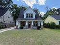 Beautiful two-story home featuring a well-manicured lawn and inviting front porch with brick detailing at 339 Morgan Se Pl, Atlanta, GA 30317