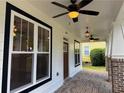Covered porch showcasing stylish lighting fixtures, fan, and brick flooring for a cozy outdoor space at 339 Morgan Se Pl, Atlanta, GA 30317