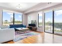 Airy living room boasting hardwood floors, large windows, and sliding glass doors to a balcony at 3445 Stratford Ne Rd # 903, Atlanta, GA 30326