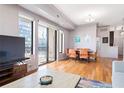 Open-concept living space featuring dining area, floor-to-ceiling windows, and sliding doors to balcony at 3445 Stratford Ne Rd # 903, Atlanta, GA 30326