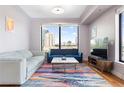 Bright living room with hardwood floors, city views and a colorful rug at 3445 Stratford Ne Rd # 903, Atlanta, GA 30326