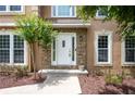 Close-up of an inviting doorway framed by stone accents and meticulously landscaped details at 313 Clubhouse Nw Ct, Kennesaw, GA 30144