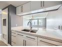 Modern kitchen with white cabinets, stainless steel faucet and marble countertops at 3481 Lakeside Ne Dr # 1107, Atlanta, GA 30326