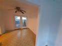 A cozy living room with fan and glass patio doors leading to the outdoor space at 3252 Pinehill Dr, Decatur, GA 30032