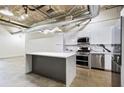 Modern kitchen boasts stainless appliances, sleek white cabinets, and marble countertops at 505 Whitehall Sw St # 102, Atlanta, GA 30303