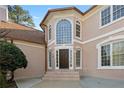 Inviting front entrance with a large arched window and classic architectural details at 971 Ashebrooke Ne Ct, Marietta, GA 30068
