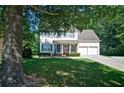Charming two-story house with blue shutters and an attached two-car garage at 809 Longbranch Ln, Douglasville, GA 30134