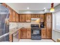 Traditional kitchen featuring wood cabinets, granite countertops and stainless steel appliances at 1144 Country Ct, Lawrenceville, GA 30044