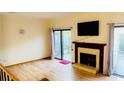 Bright living room with a fireplace, hardwood floors, and sliding door access to the outside at 1144 Country Ct, Lawrenceville, GA 30044