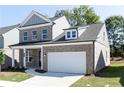 Attractive two-story brick home featuring a covered porch and attached two-car garage at 1517 Ellie Ridge Ave, Lawrenceville, GA 30043