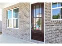 Close-up of a stylish front door with glass panels, flanked by bright, modern windows at 1517 Ellie Ridge Ave, Lawrenceville, GA 30043