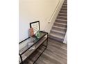 Well-lit foyer of the townhome featuring wood floors and a staircase at 536 Magnolia Cir # 116, Palmetto, GA 30268