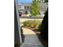 Inviting walkway leading through the front yard of a townhome with fresh landscaping at 536 Magnolia Cir # 116, Palmetto, GA 30268