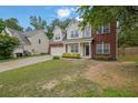 Lovely two-story home with a brick and siding exterior, complemented by a well-maintained lawn and attached garage at 6341 Stewart Ridge Walk, Buford, GA 30518