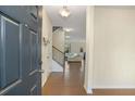 Inviting entryway with hardwood floors, staircase, and a view into the spacious living area at 105 Paulowina Cir, Mcdonough, GA 30253