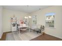 Bright office with natural light, desk, chair, shelving unit, and decorative rug at 105 Paulowina Cir, Mcdonough, GA 30253