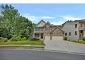 A charming two-story home with a well-maintained lawn, mature trees, and a spacious driveway on a clear day at 204 Starwood Ct, Acworth, GA 30102