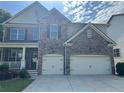 Attractive two-story house with stone and siding, featuring a two-car garage and a welcoming front porch area at 204 Starwood Ct, Acworth, GA 30102