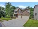 Beautiful two-story home with brick and stone accents, a lush lawn, and a wide driveway for easy parking at 204 Starwood Ct, Acworth, GA 30102