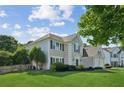 Two-story home with manicured lawn, black shutters, and picket fence at 7025 Coffield Ct, Cumming, GA 30041