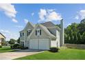 Traditional two-story home with an attached two-car garage at 7025 Coffield Ct, Cumming, GA 30041