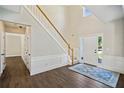 Welcoming home foyer featuring hardwood floors, high ceilings, and an elegant staircase at 7025 Coffield Ct, Cumming, GA 30041