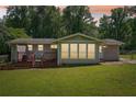 Spacious backyard with a wooden deck and ample green space at 905 Scott Sw Ln, Marietta, GA 30008