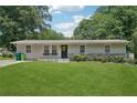 Attractive single-story home featuring a lush lawn and flowerbeds enhancing curb appeal at 905 Scott Sw Ln, Marietta, GA 30008