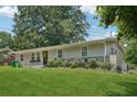Well-maintained single-story home with an inviting front lawn and mature landscaping at 905 Scott Sw Ln, Marietta, GA 30008