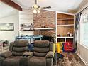 Welcoming living room featuring a brick fireplace, built-in shelves, and hardwood floors at 224 Potts Se Rd, Conyers, GA 30094