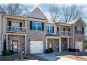 Attractive townhouse exterior with stone accents, small porch, and a one-car garage at 2544 Castellan Dr, Atlanta, GA 30316