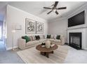 Cozy living room with neutral walls, fireplace, plush sectional, and modern decor at 2544 Castellan Dr, Atlanta, GA 30316