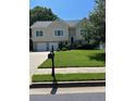 Traditional two-story home with a well-manicured front yard and a two-car garage at 318 Summit View Dr, Mcdonough, GA 30253