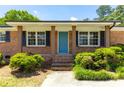 A front entrance with a bright blue door and brick facade with brown columns at 4172 N Martin Way, Lithia Springs, GA 30122