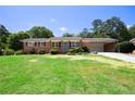 Charming brick home with a well-maintained lawn and blue door on a sunny day at 4172 N Martin Way, Lithia Springs, GA 30122