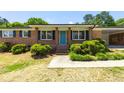 Close up of the front porch with a bright blue door and brick facade at 4172 N Martin Way, Lithia Springs, GA 30122