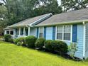Light blue single story home with blue shutters and a manicured front yard at 60 Parkman Trl, Covington, GA 30016