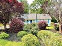 Charming home with a well-maintained front yard and colorful landscaping at 60 Parkman Trl, Covington, GA 30016