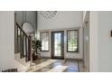 Bright entryway featuring a stylish chandelier, hardwood floors, and a staircase with a dark wood banister at 0 Paige St, Dallas, GA 30157