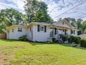 Charming single-Gathering home with a well-manicured front lawn and white painted brick at 3215 Woodview Se Dr, Smyrna, GA 30082